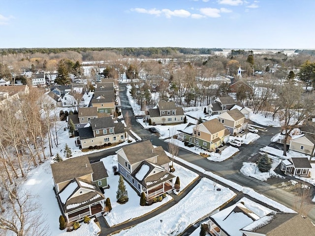 snowy aerial view with a residential view