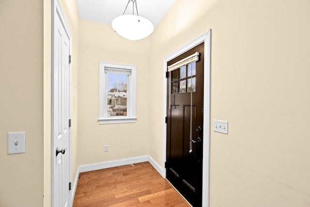 entryway with baseboards and light wood-style floors