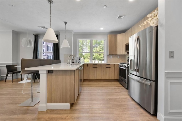 320 Middlesex Ave Unit B109, Medford, MA 02155 - kitchen featuring appliances with stainless steel finishes, a peninsula, a sink, modern cabinets, and light countertops