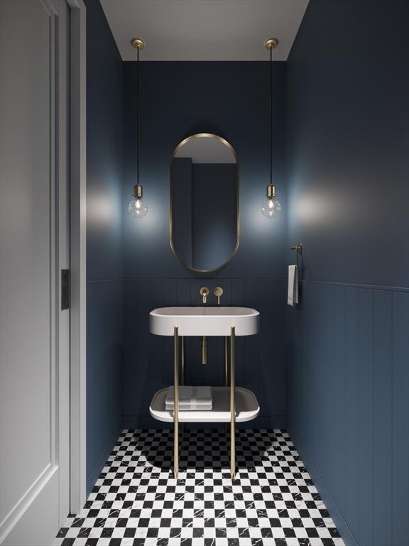 1114 Beacon St Unit 102, Newton, MA 02461 - bathroom featuring a sink, tile patterned floors, wainscoting, and a decorative wall