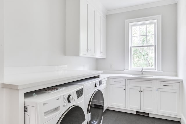 laundry room with ornamental molding, cabinets, sink, and washer and dryer