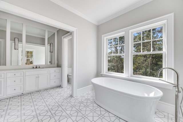 bathroom featuring a tub, ornamental molding, vanity, tile patterned floors, and toilet