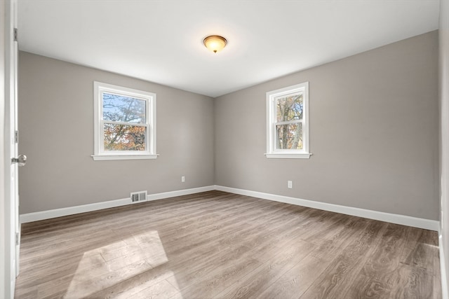 unfurnished room with light hardwood / wood-style floors