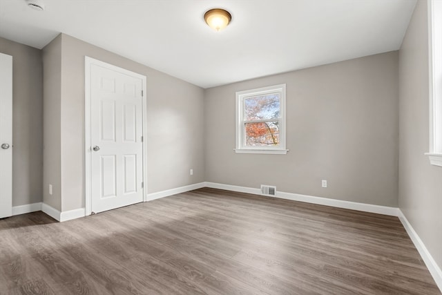 spare room with dark hardwood / wood-style flooring