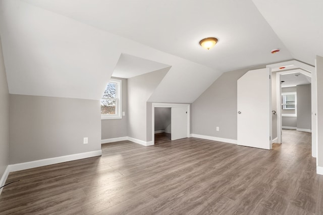 additional living space with dark hardwood / wood-style flooring and lofted ceiling