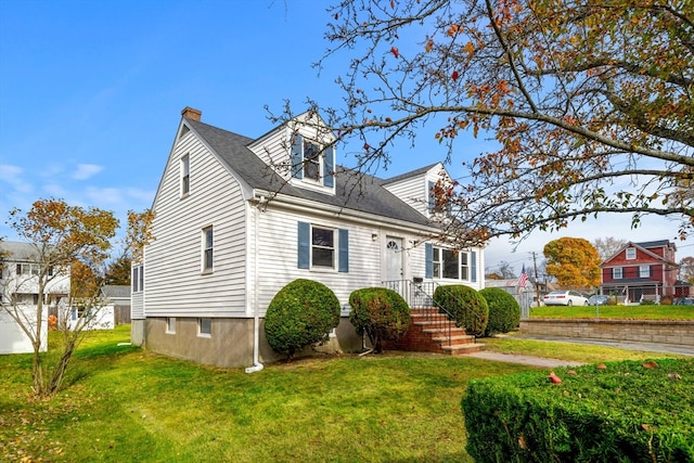 cape cod home featuring a front yard