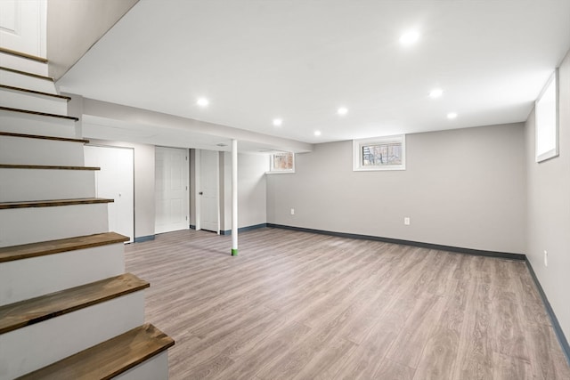 basement with light hardwood / wood-style floors and plenty of natural light