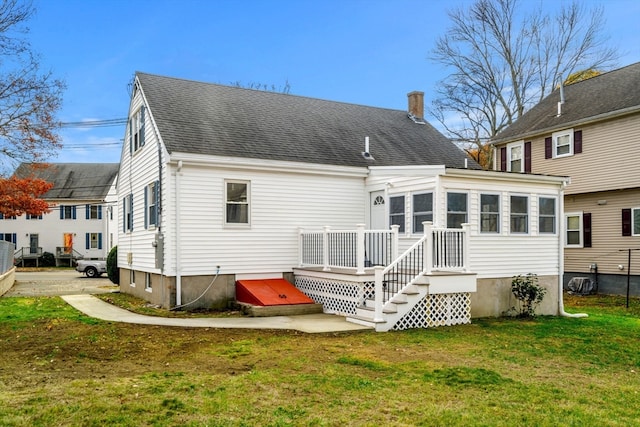 rear view of property featuring a yard