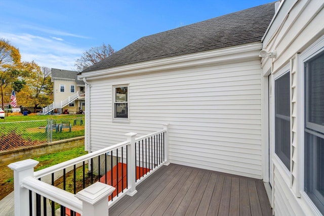 wooden terrace featuring a lawn