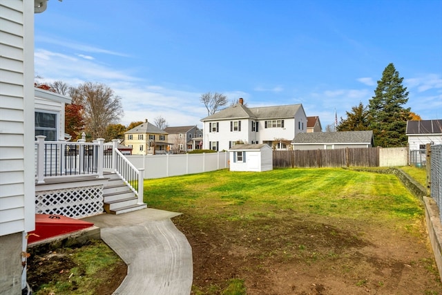 view of yard with a storage shed and a wooden deck