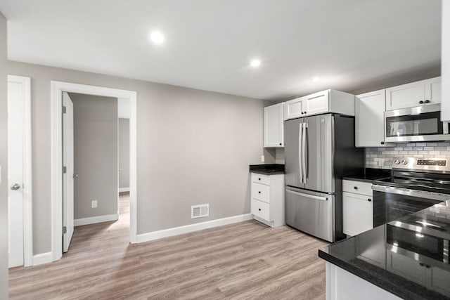 kitchen featuring stainless steel appliances, light hardwood / wood-style floors, white cabinetry, and tasteful backsplash