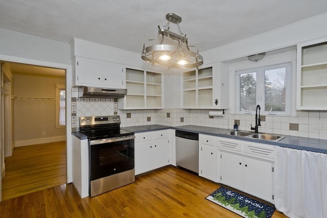 kitchen with open shelves, stainless steel appliances, dark countertops, a sink, and under cabinet range hood