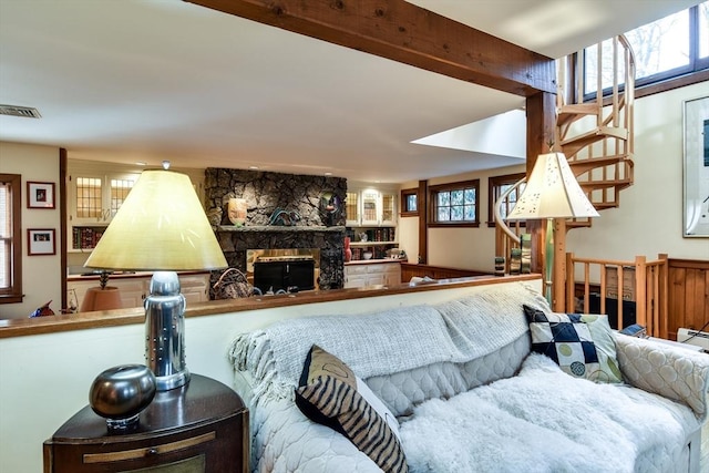 living room with a fireplace and beam ceiling