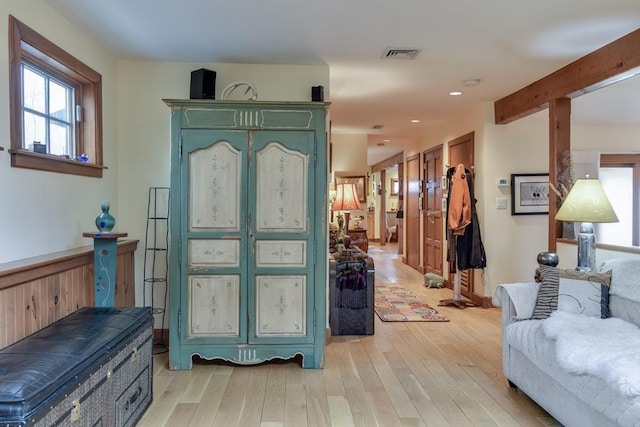 foyer entrance with beam ceiling and light hardwood / wood-style floors