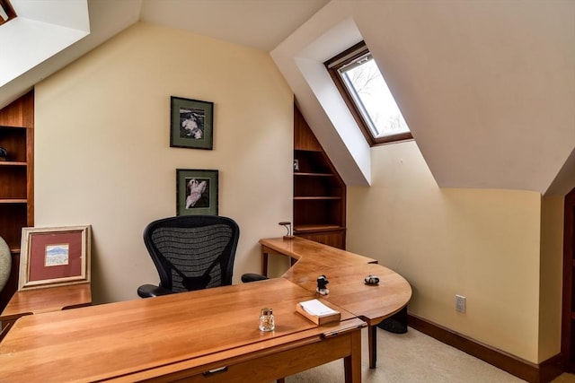 office space with lofted ceiling with skylight and light carpet