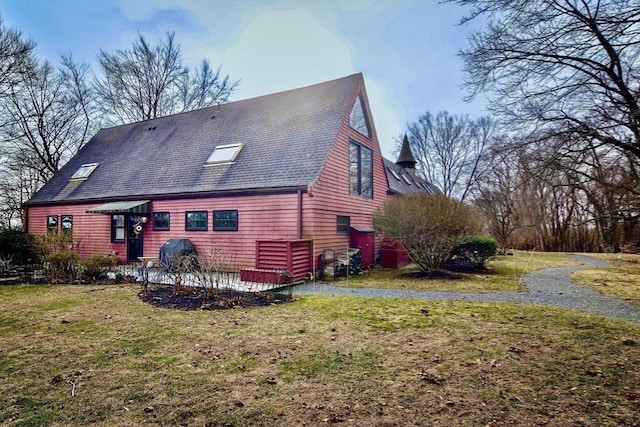 back of property with a lawn