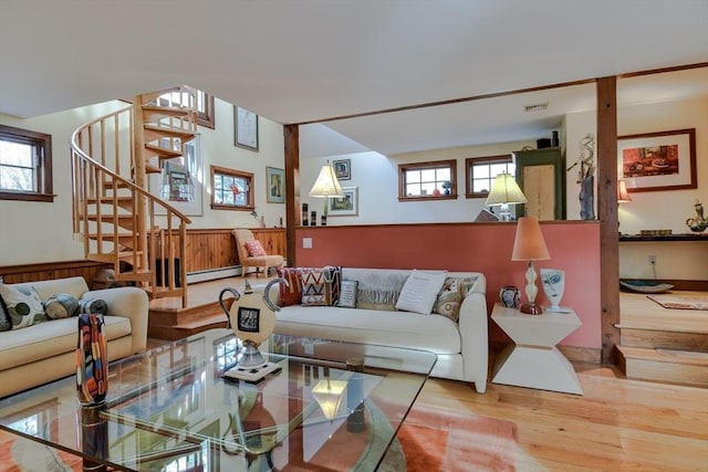 living room with hardwood / wood-style flooring and a baseboard heating unit