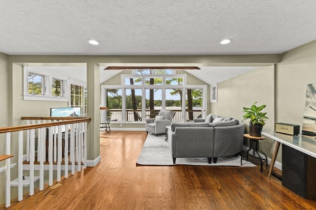 192 Furnace Ln, Pembroke, MA 02359 - living room featuring a textured ceiling, wood finished floors, recessed lighting, baseboards, and lofted ceiling