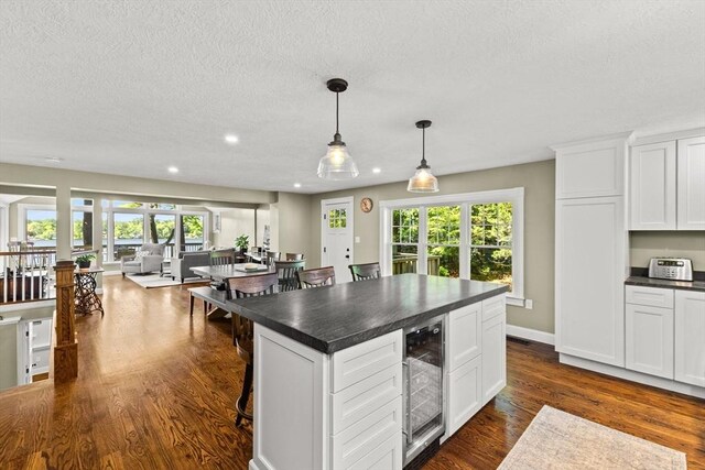 192 Furnace Ln, Pembroke, MA 02359 - kitchen featuring wine cooler, dark countertops, plenty of natural light, recessed lighting, and a textured ceiling