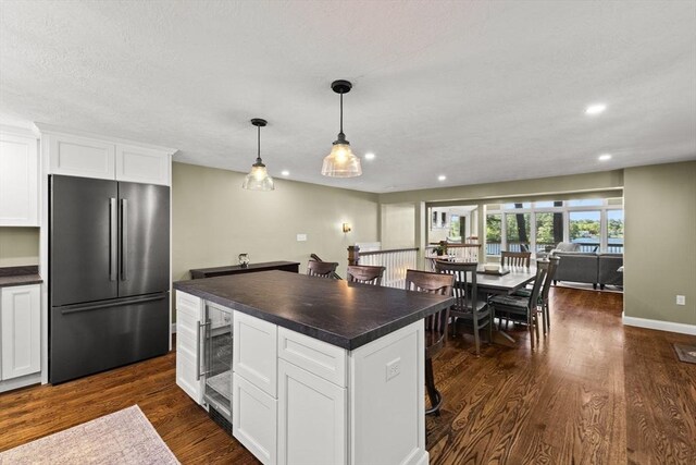 192 Furnace Ln, Pembroke, MA 02359 - kitchen with stainless steel fridge, dark countertops, wine cooler, dark wood-style flooring, and recessed lighting