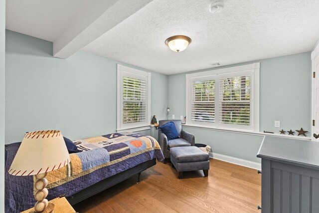 192 Furnace Ln, Pembroke, MA 02359 - bedroom featuring wood finished floors, baseboards, and a textured ceiling
