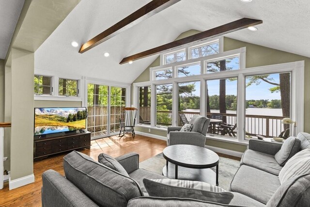 192 Furnace Ln, Pembroke, MA 02359 - living area featuring healthy amount of natural light, beam ceiling, wood finished floors, baseboards, and high vaulted ceiling
