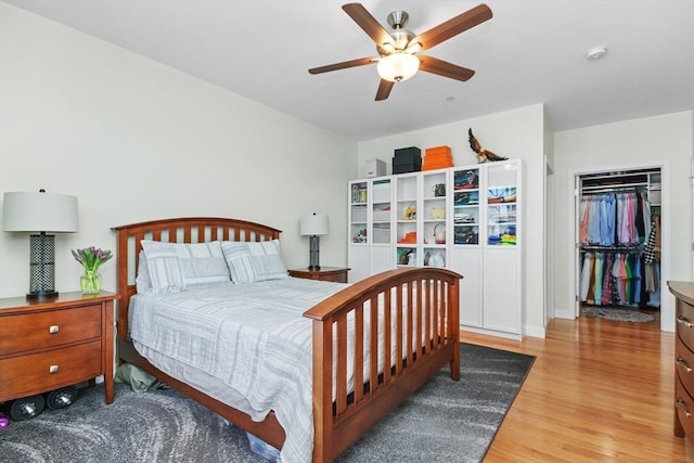 bedroom featuring ceiling fan, a closet, and hardwood / wood-style floors