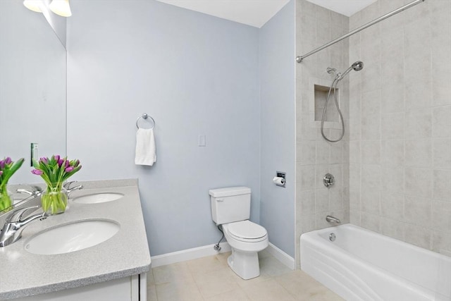 full bathroom with toilet, tile patterned flooring, tiled shower / bath, and vanity