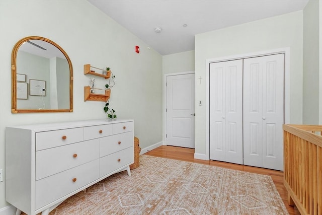 unfurnished bedroom with light hardwood / wood-style floors and a closet