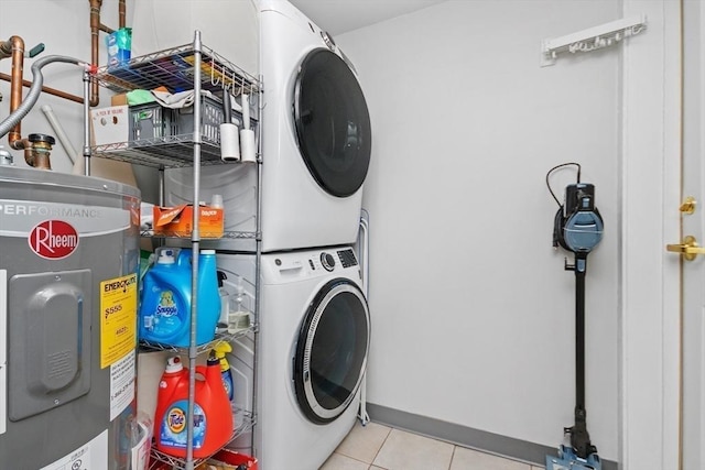 laundry area with water heater, light tile patterned floors, and stacked washer / drying machine