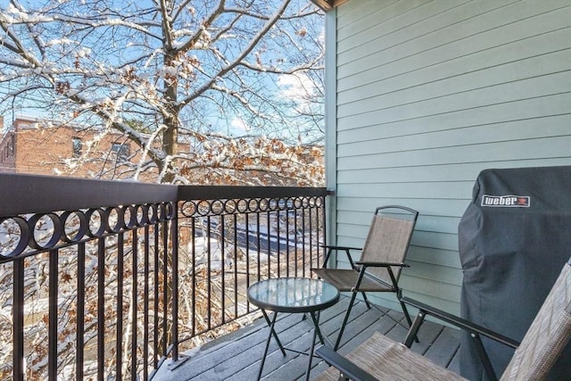 snow covered back of property featuring area for grilling