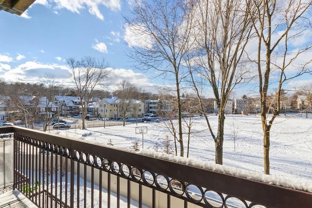 view of snow covered back of property