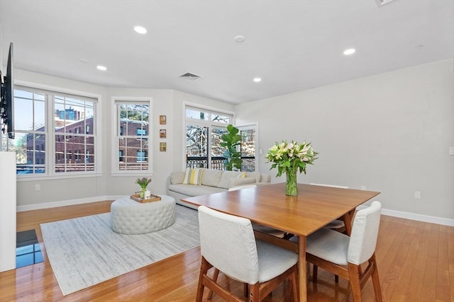 dining room featuring a healthy amount of sunlight and light hardwood / wood-style floors