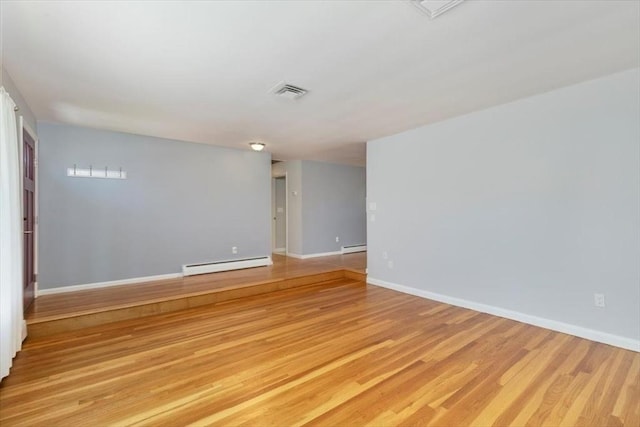150 Gore Rd, Revere, MA 02151 - spare room featuring a baseboard heating unit and light wood-style flooring