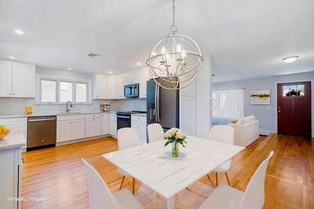 150 Gore Rd, Revere, MA 02151 - dining space with a chandelier, light wood-type flooring, and recessed lighting