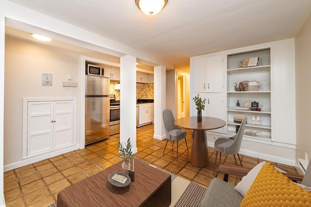 9 Hancock St Unit 1, Boston, MA 02114 - dining area featuring built in shelves, light tile patterned floors, and baseboards