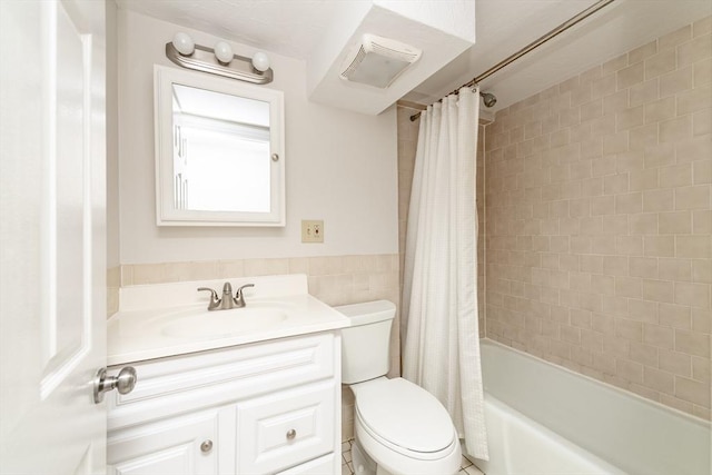 9 Hancock St Unit 1, Boston, MA 02114 - bathroom featuring toilet, vanity, tile walls, and shower / bath combo