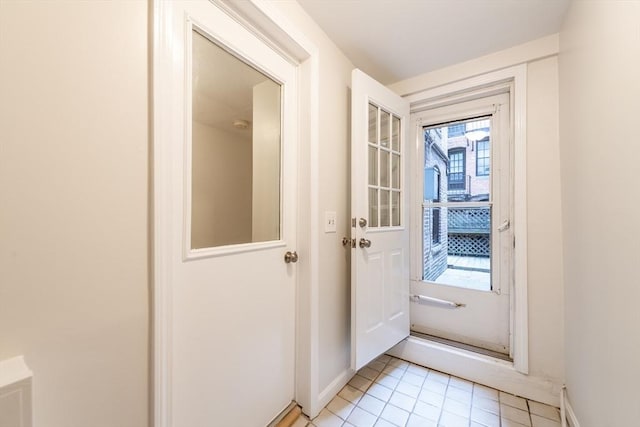 9 Hancock St Unit 1, Boston, MA 02114 - doorway to outside with light tile patterned floors and baseboards