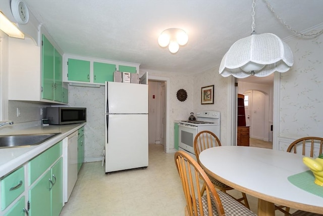 12 Bay State Rd, Natick, MA 01760 - kitchen with white appliances, a sink, arched walkways, wallpapered walls, and light countertops