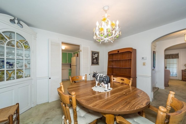 12 Bay State Rd, Natick, MA 01760 - dining area with arched walkways, a chandelier, and light carpet