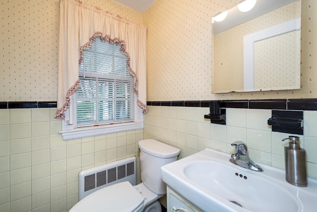 12 Bay State Rd, Natick, MA 01760 - bathroom featuring radiator heating unit, wallpapered walls, a sink, toilet, and wainscoting