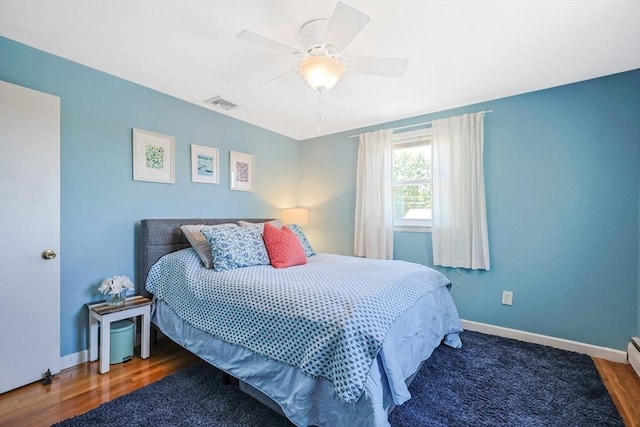 bedroom with baseboards, wood finished floors, and a ceiling fan