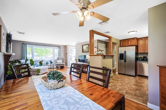 dining room with ceiling fan and light wood-style floors