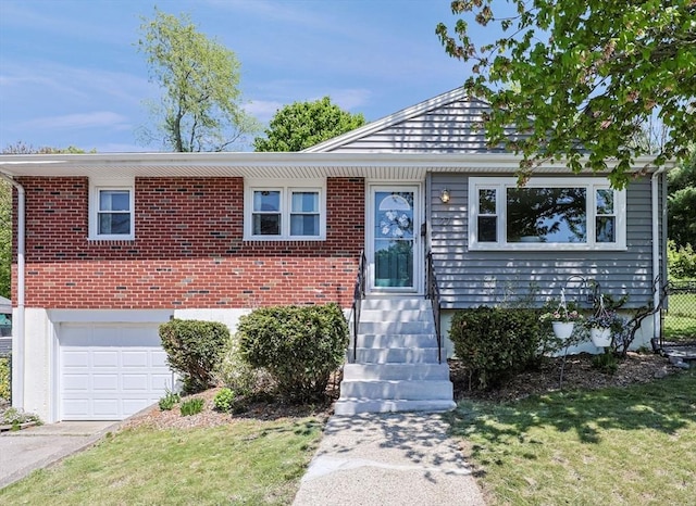 view of front of property featuring a garage, a front lawn, and brick siding