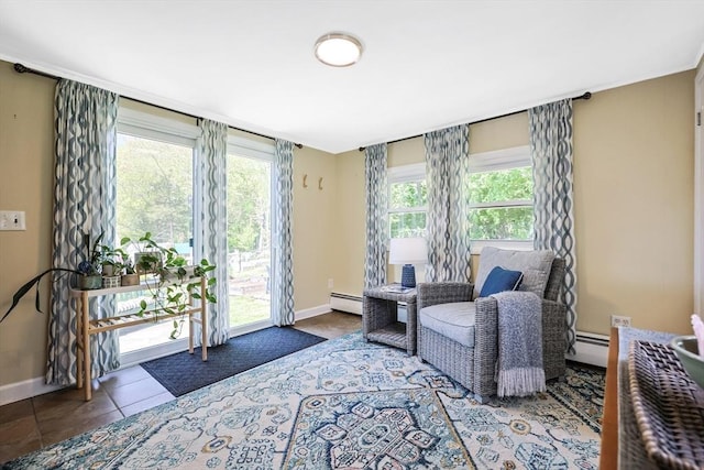 living area with baseboard heating, baseboards, and tile patterned flooring