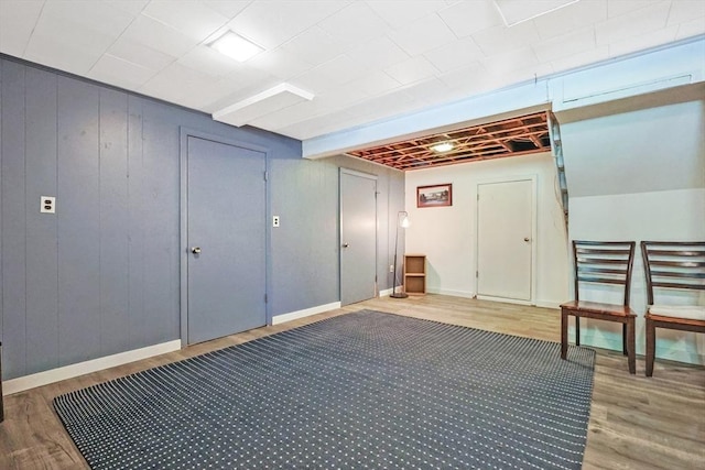finished basement with wood finished floors and baseboards