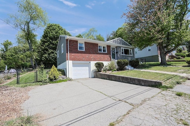 ranch-style home with asphalt driveway, an attached garage, brick siding, and a gate