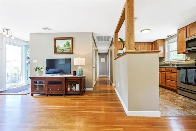 living area with light wood-style floors and baseboards