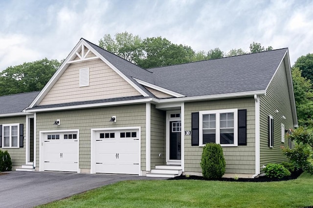 10 Soucy Dr Unit 10, Rutland, MA 01543 - view of front of house featuring a garage, asphalt driveway, a front lawn, and a shingled roof