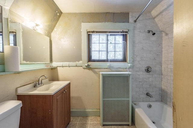 full bathroom with tile patterned floors, toilet, tiled shower / bath, vaulted ceiling, and vanity